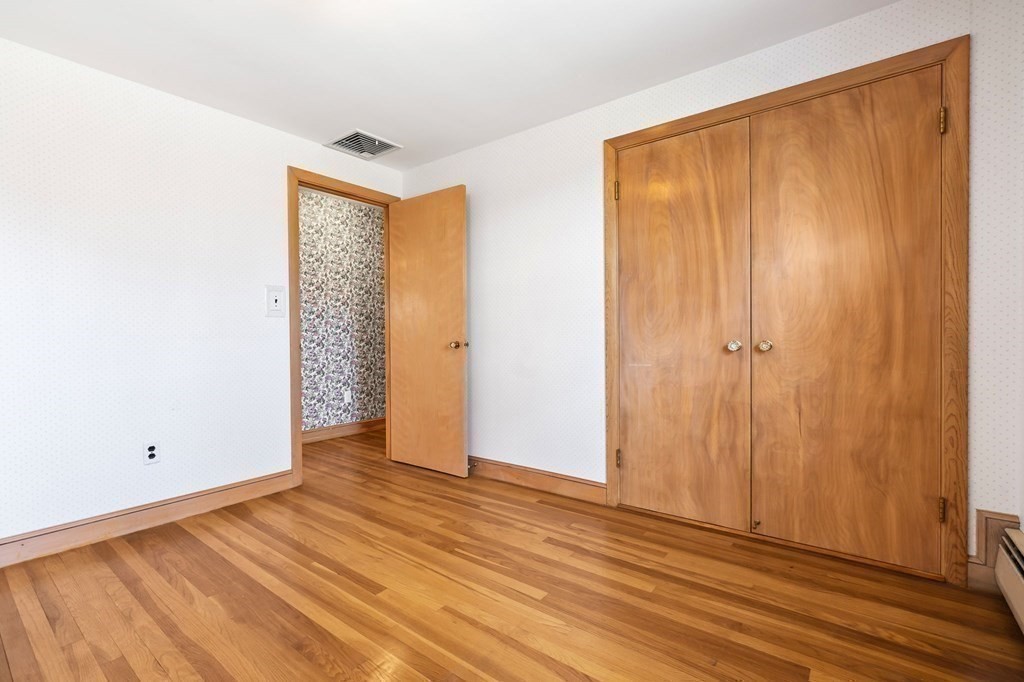 11 Haven Way Beverly, MA 01915 - Photo 16 of 29 an empty room with wooden floor and a window