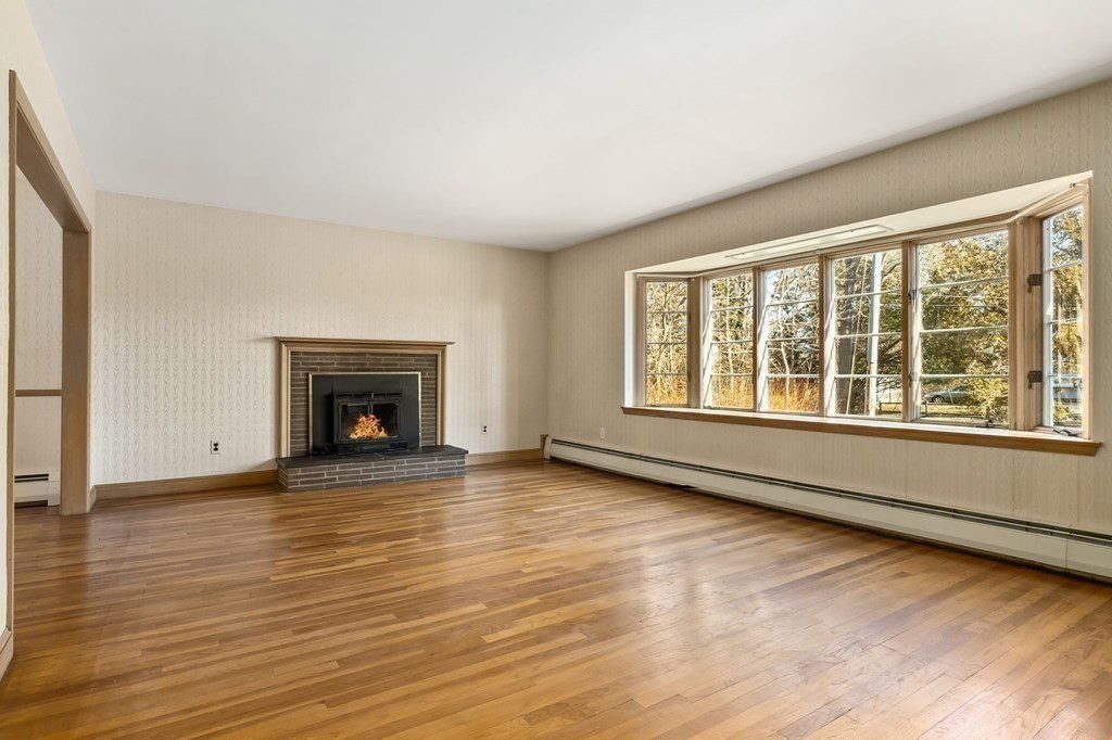 11 Haven Way Beverly, MA 01915 - Photo 5 of 29 a view of an empty room with wooden floor and a window