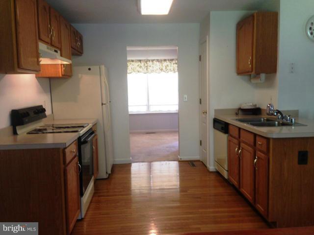 1801 Lottie Fowler Road Prince Frederick, MD 20678 - Photo 12 of 21 a kitchen with stainless steel appliances granite countertop a stove a sink and a refrigerator