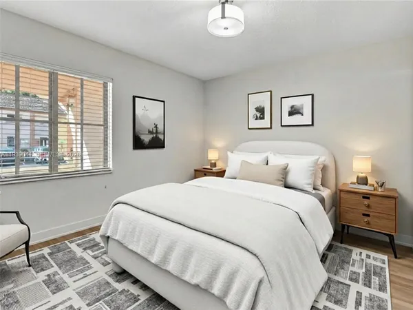 an empty room with wooden floor and window