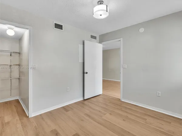 a view of a room with wooden floor and a window