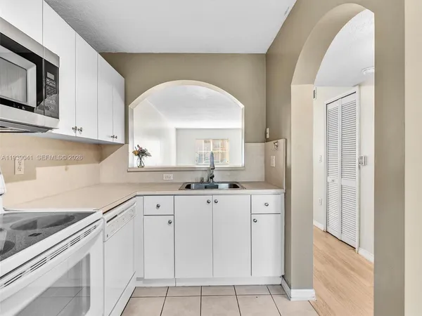 a kitchen with cabinets appliances and a sink