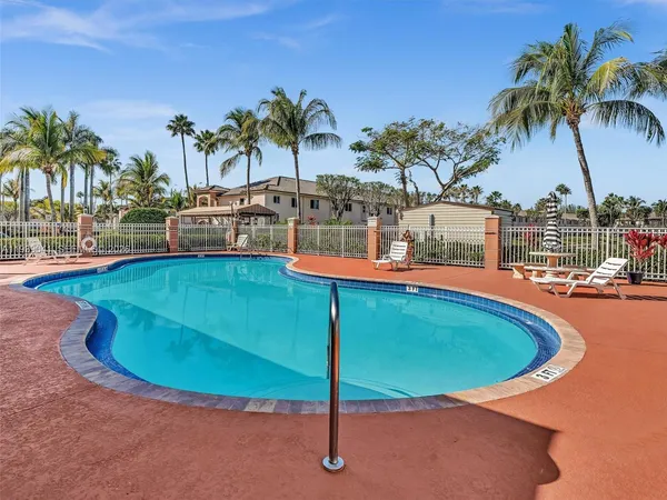 a view of a swimming pool with a table and chairs