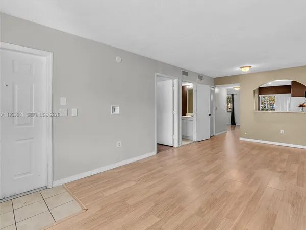 a view of empty room with wooden floor
