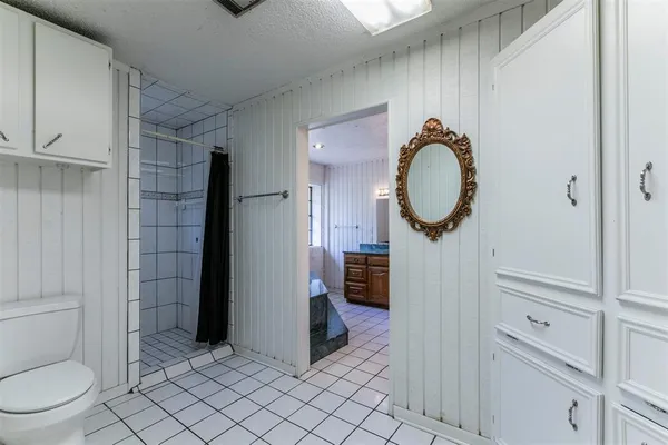 a bathroom with a toilet and a shower