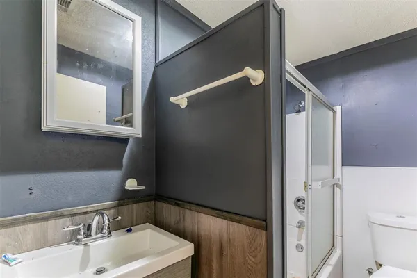 a view of an empty room with a window and a chandelier