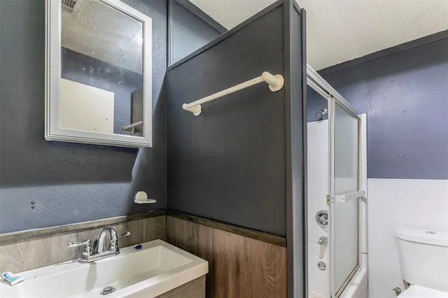 a view of an empty room with a window and a chandelier