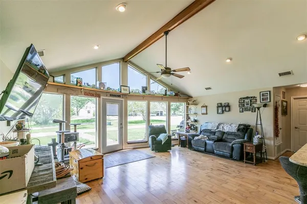 a living room with lots of furniture and kitchen view