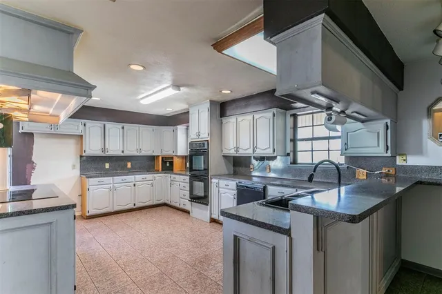 a kitchen that has a sink and a stove in it