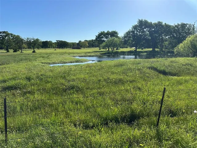a view of a lake and green valley
