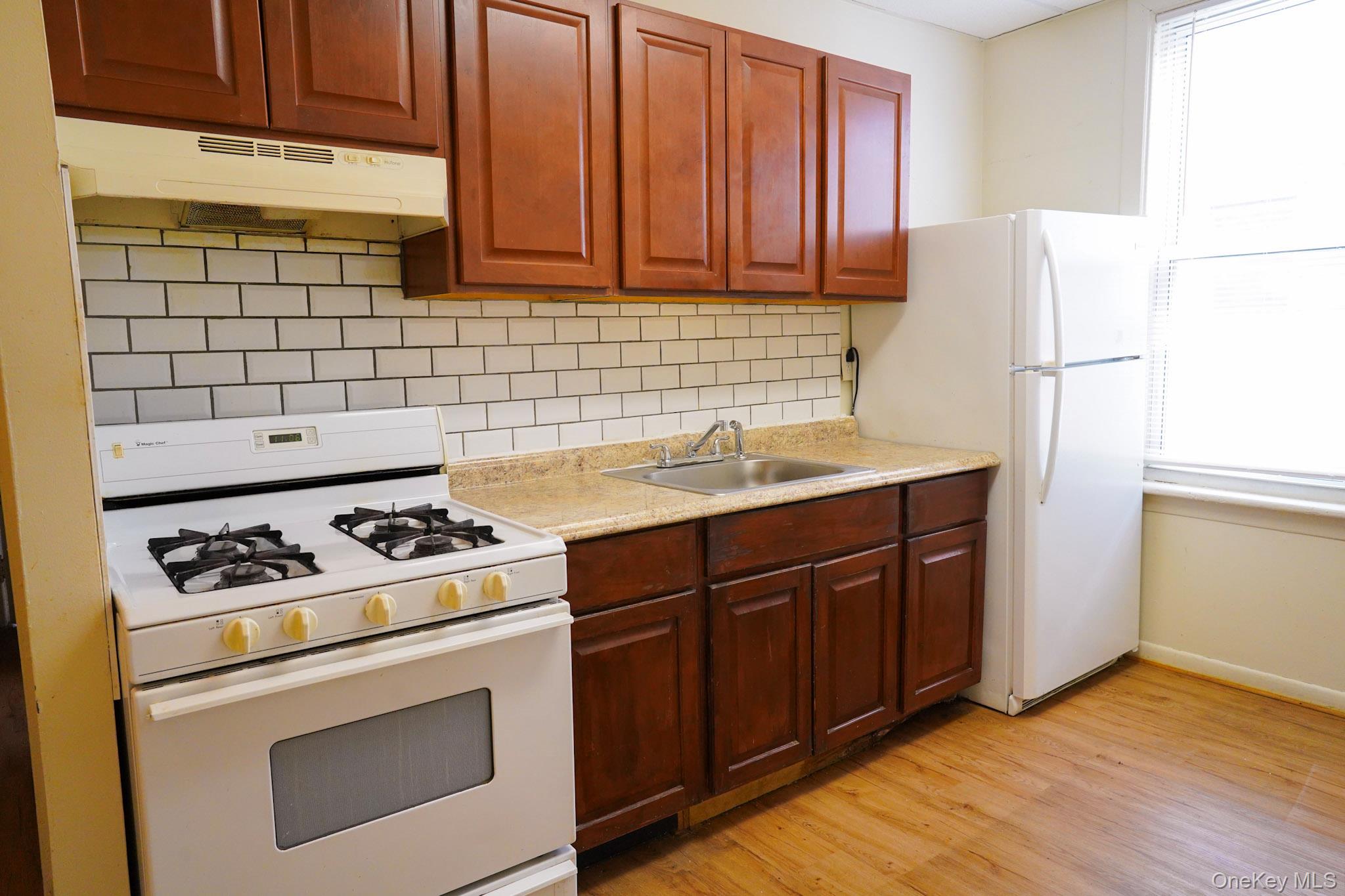 80-33 90th Road Queens, NY 11421 - Photo 12 of 20 a kitchen with a sink stove and refrigerator