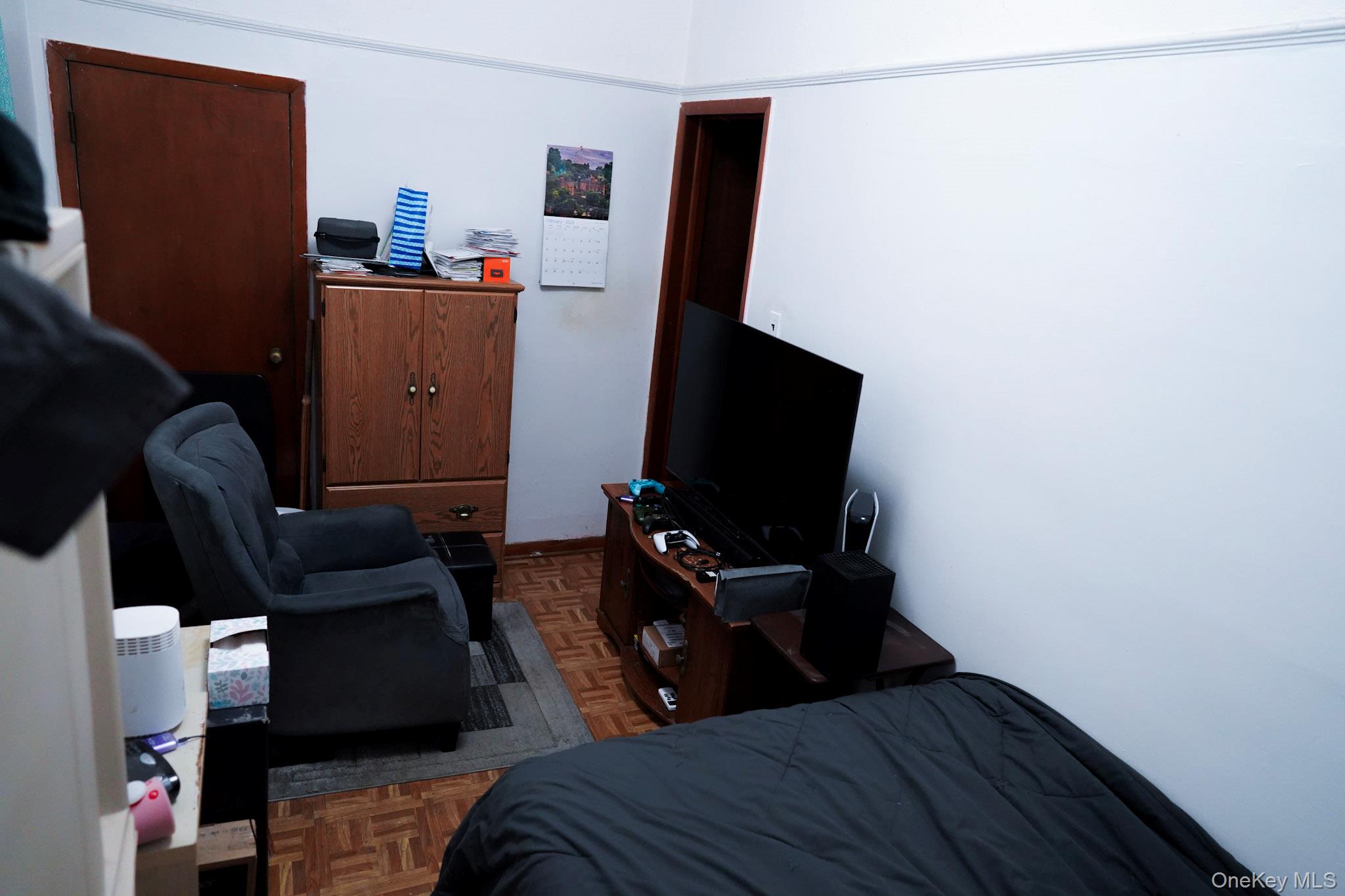80-33 90th Road Queens, NY 11421 - Photo 14 of 20 a bedroom with a bed and a flat screen tv