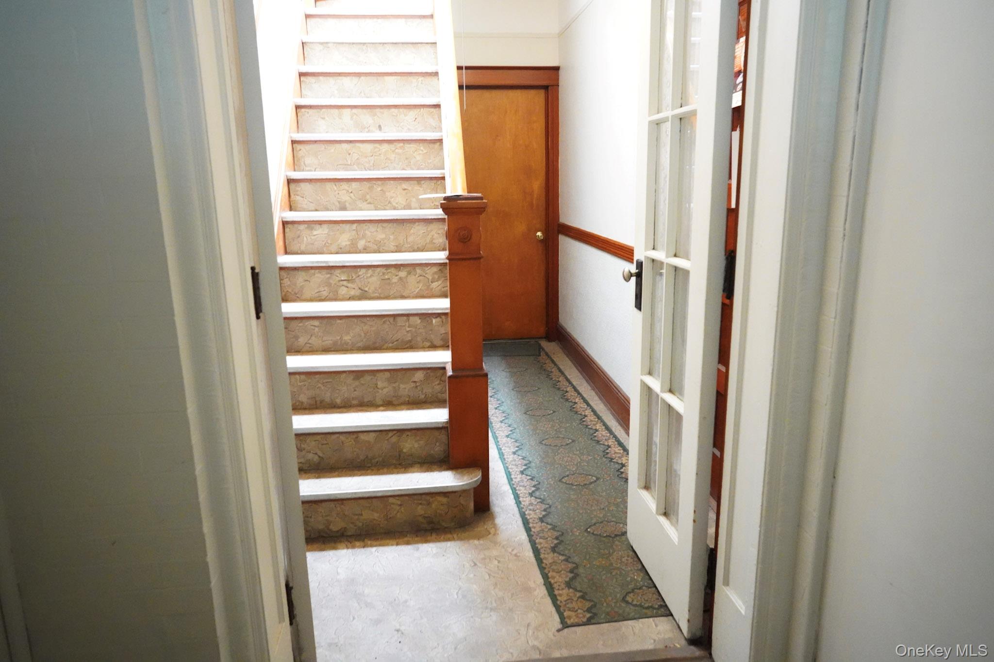 80-33 90th Road Queens, NY 11421 - Photo 4 of 20 a view of a hallway with wooden floor and entryway