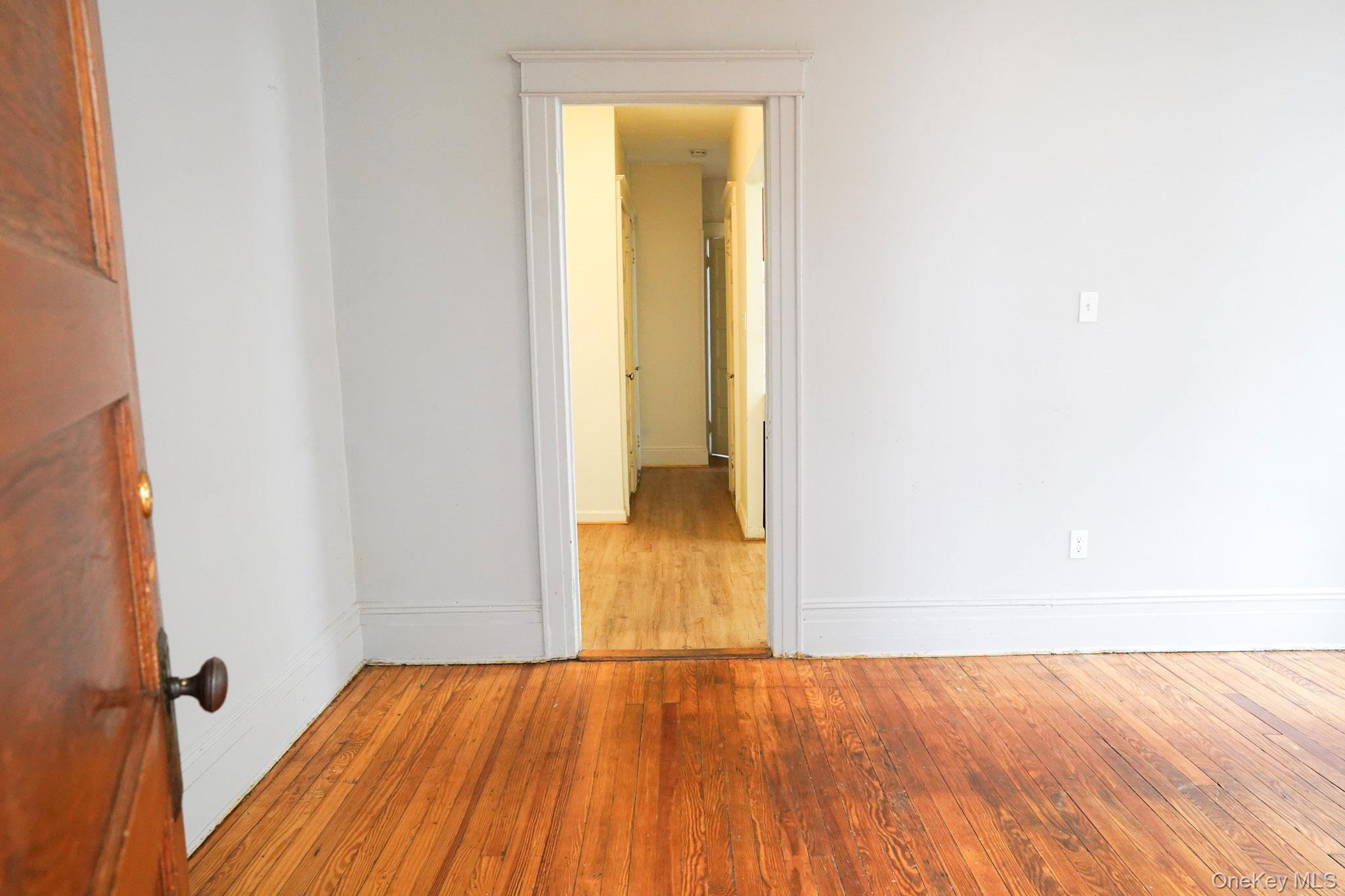 80-33 90th Road Queens, NY 11421 - Photo 7 of 20 a view of a room with wooden floor and a bathroom
