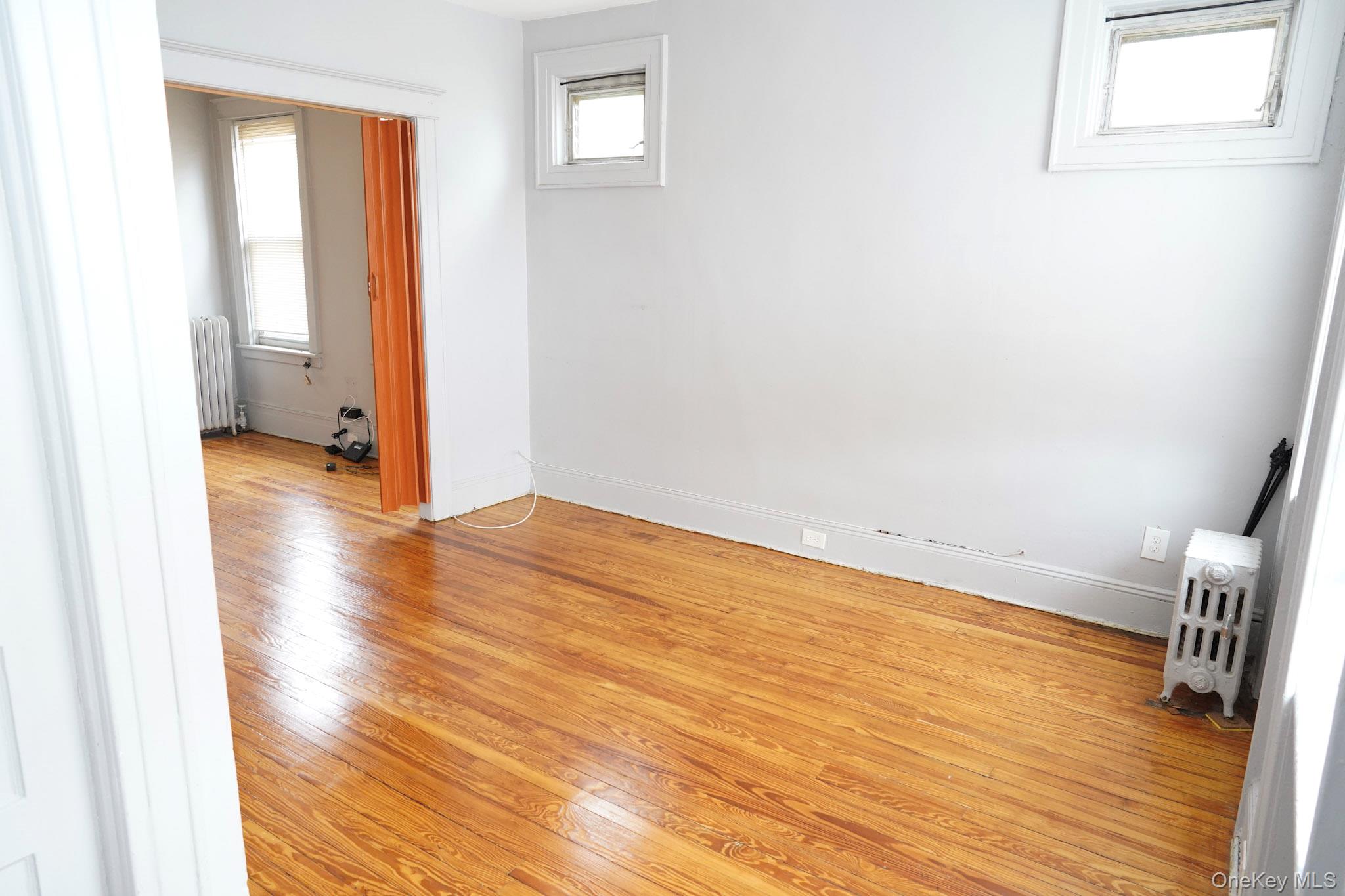 80-33 90th Road Queens, NY 11421 - Photo 8 of 20 a view of empty room with wooden floor