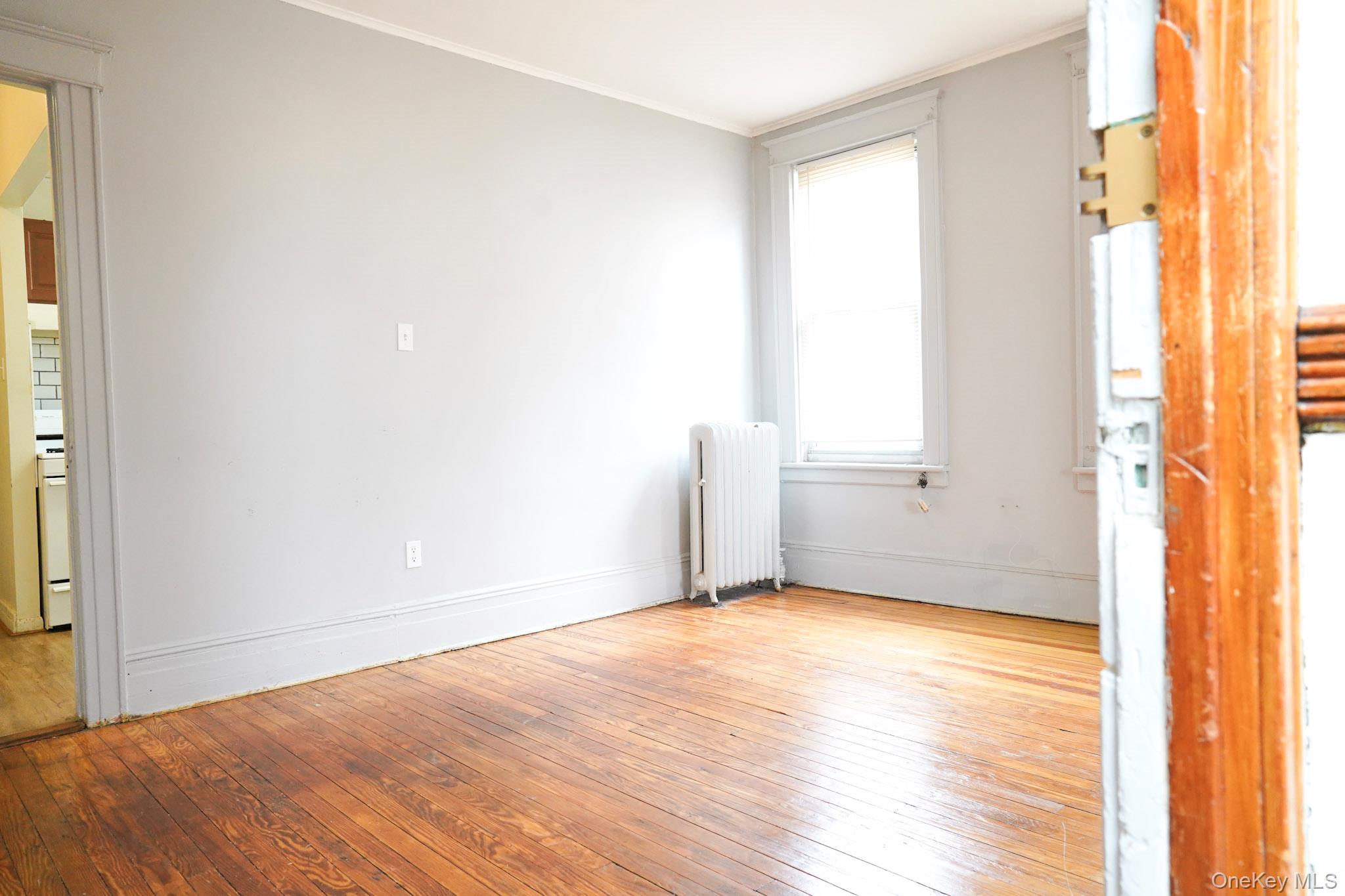 80-33 90th Road Queens, NY 11421 - Photo 9 of 20 a view of an empty room and window