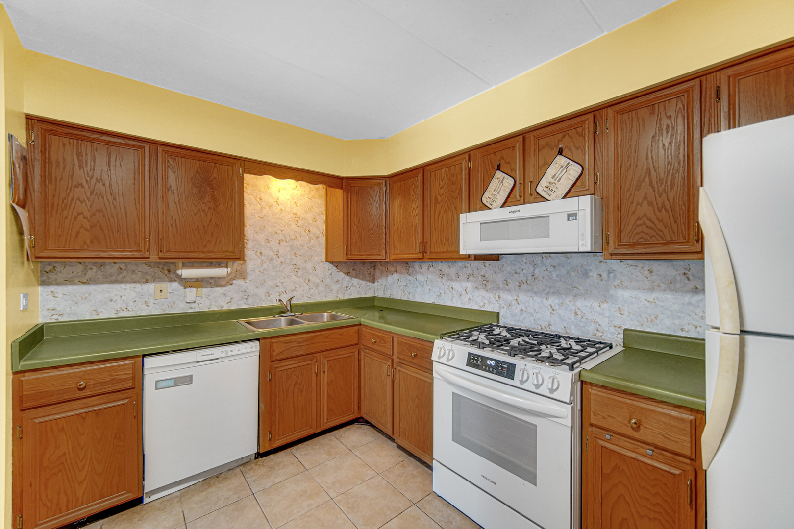 124 East Bailey Road, Unit E Naperville, IL 60565 - Photo 11 of 20 a kitchen with granite countertop cabinets stainless steel appliances and a sink