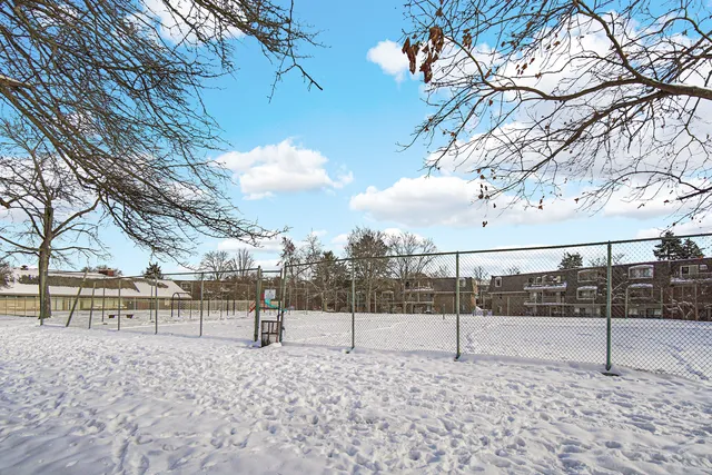 a view of park with iron fence