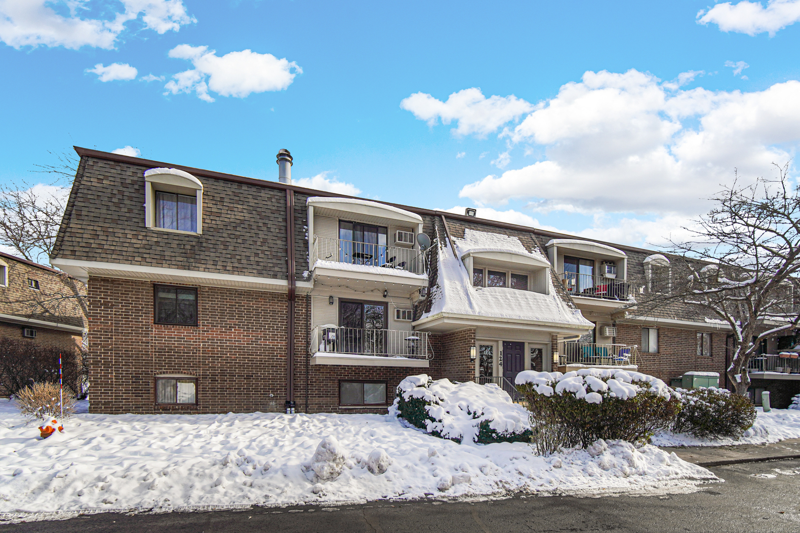 124 East Bailey Road, Unit E Naperville, IL 60565 - Photo 2 of 20 a front view of a house with a snow