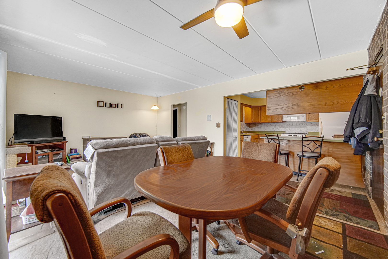124 East Bailey Road, Unit E Naperville, IL 60565 - Photo 7 of 20 a view of a dining room with furniture a kitchen and chandelier