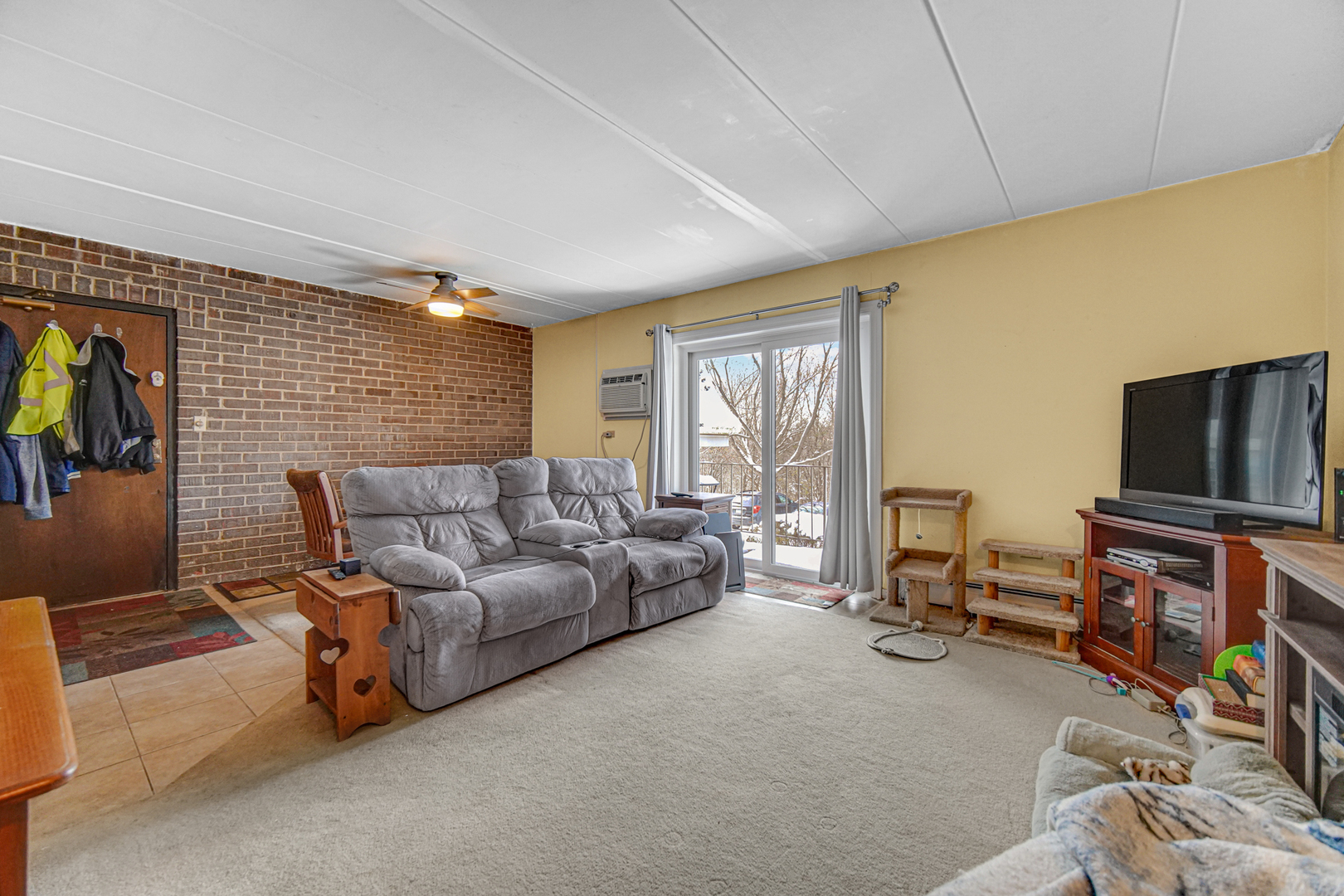124 East Bailey Road, Unit E Naperville, IL 60565 - Photo 10 of 20 a living room with furniture and a flat screen tv
