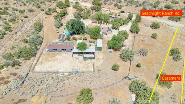 a view of a pathway with a wrought fence