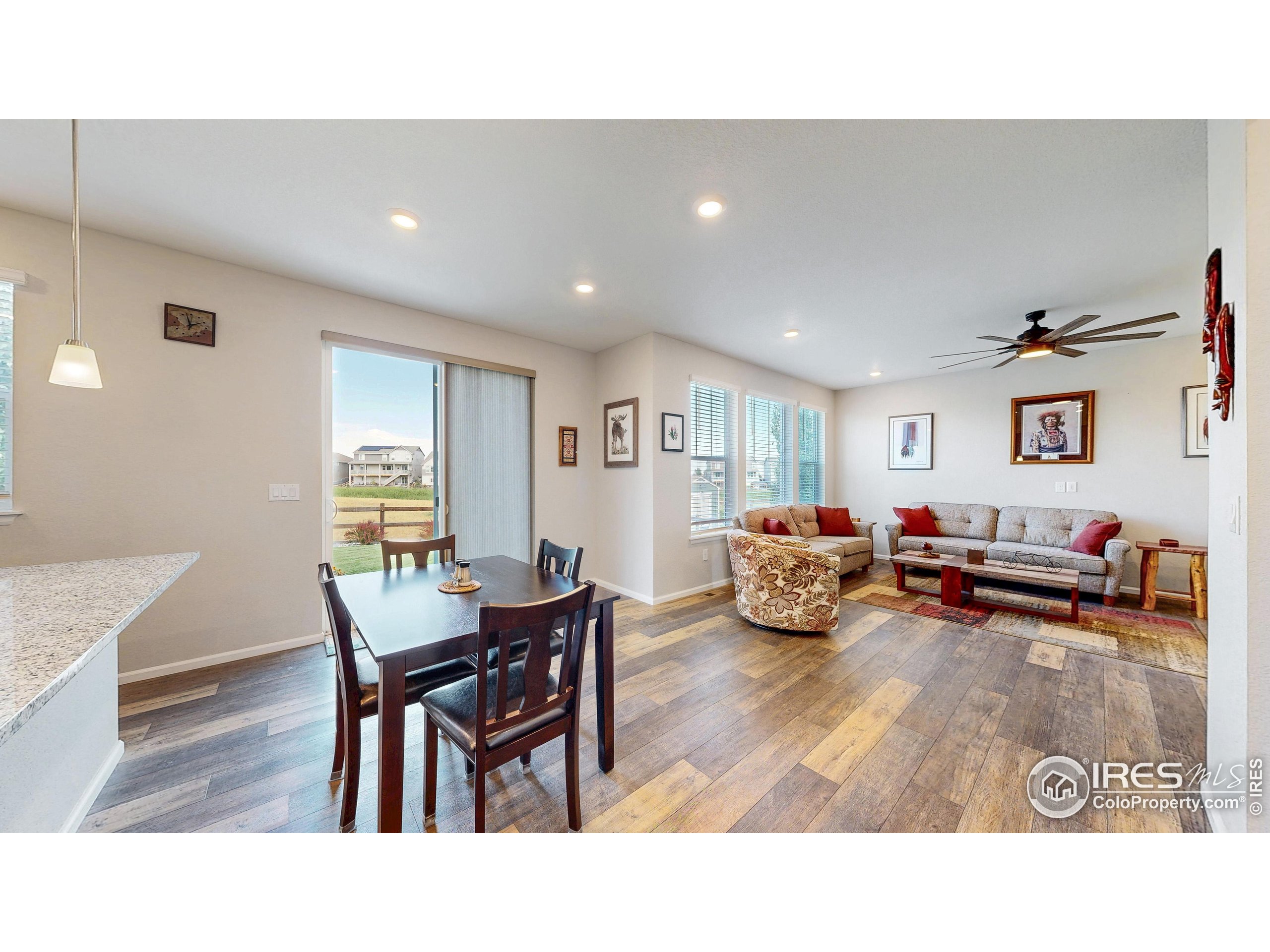 4861 St Vrain Road Firestone, CO 80504 - Photo 12 of 43 a living room with furniture and a wooden floor