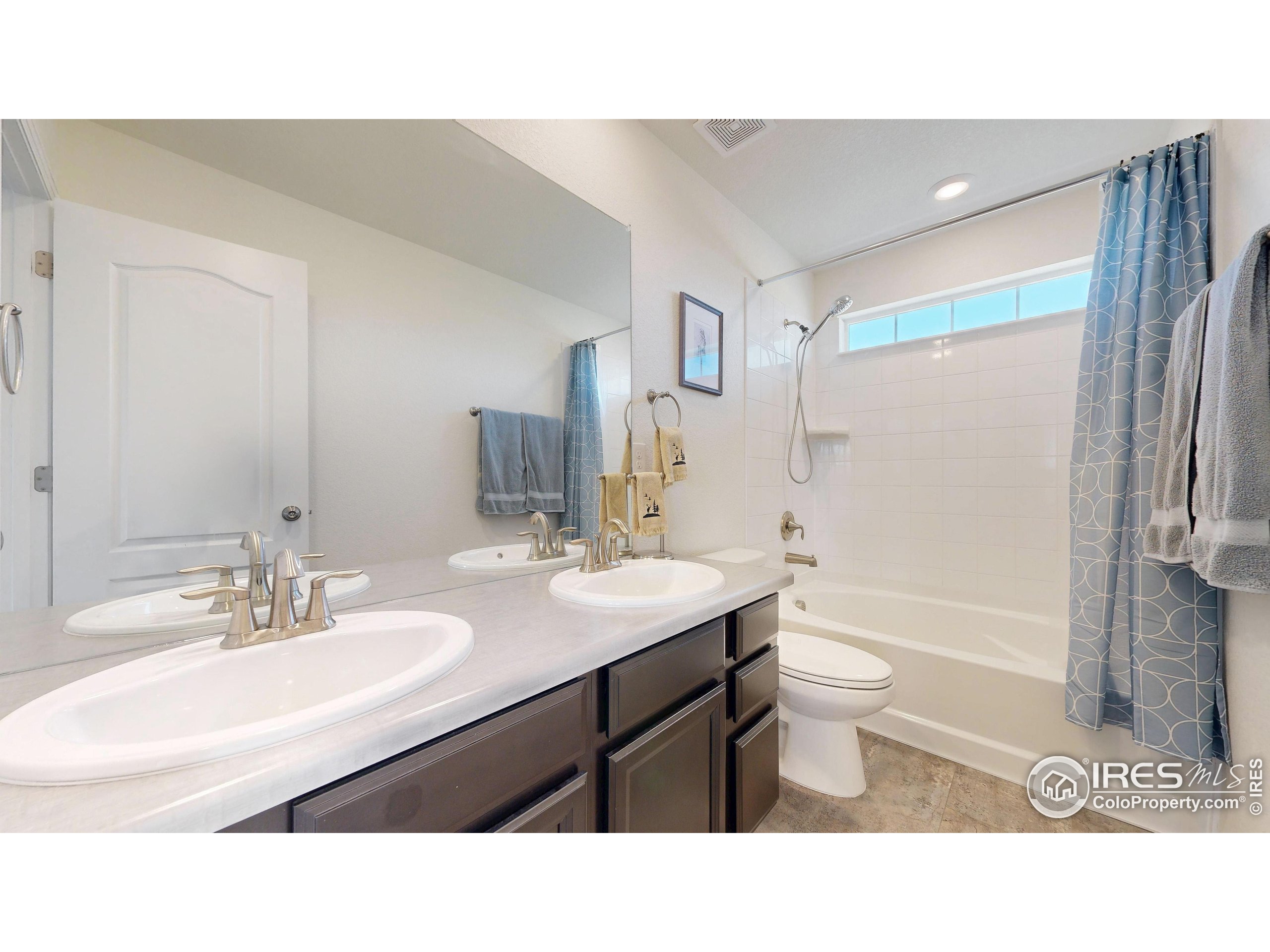 4861 St Vrain Road Firestone, CO 80504 - Photo 23 of 43 a bathroom with a sink a toilet a mirror and shower