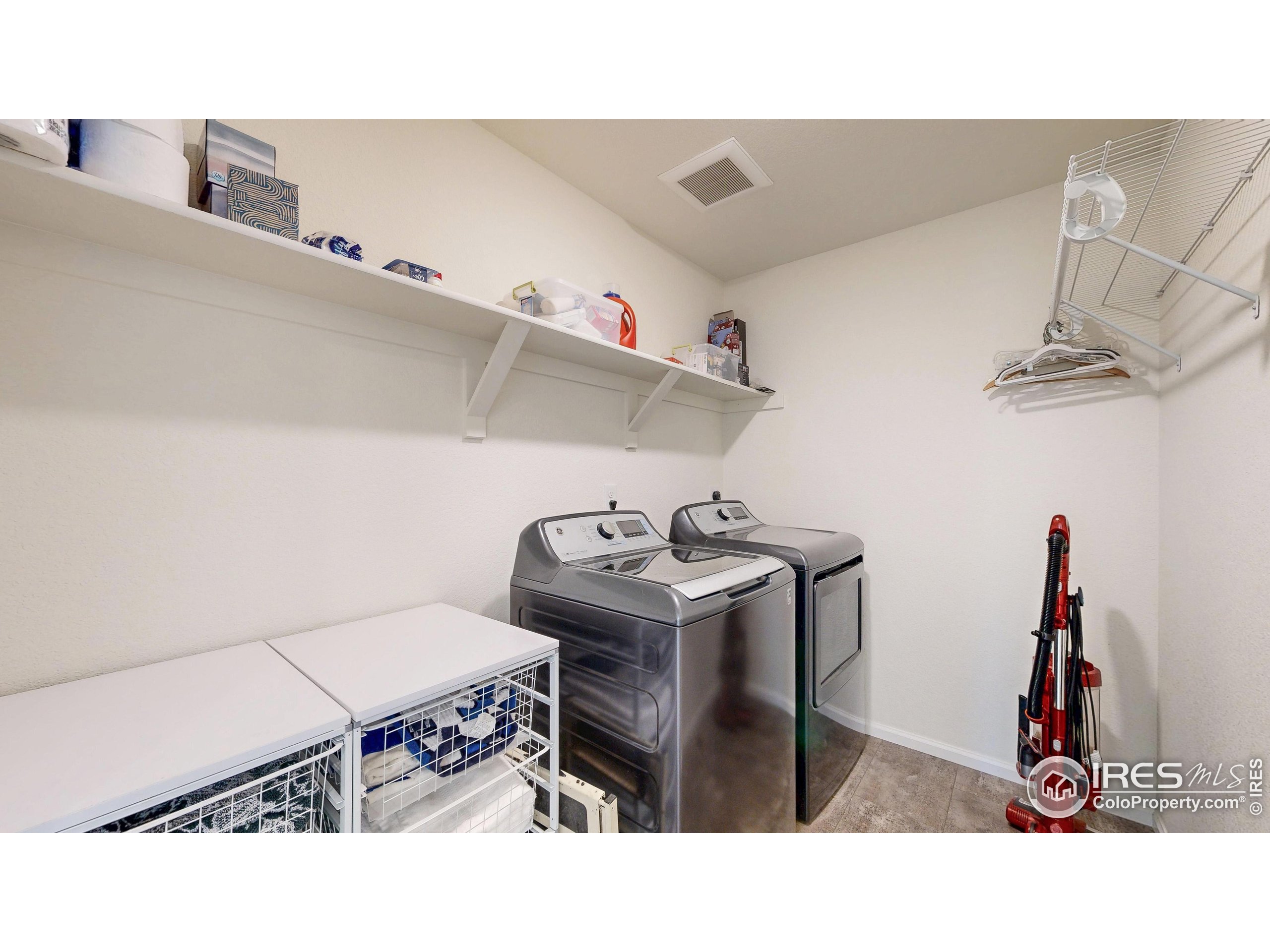 4861 St Vrain Road Firestone, CO 80504 - Photo 24 of 43 a kitchen with a stove a table and chairs