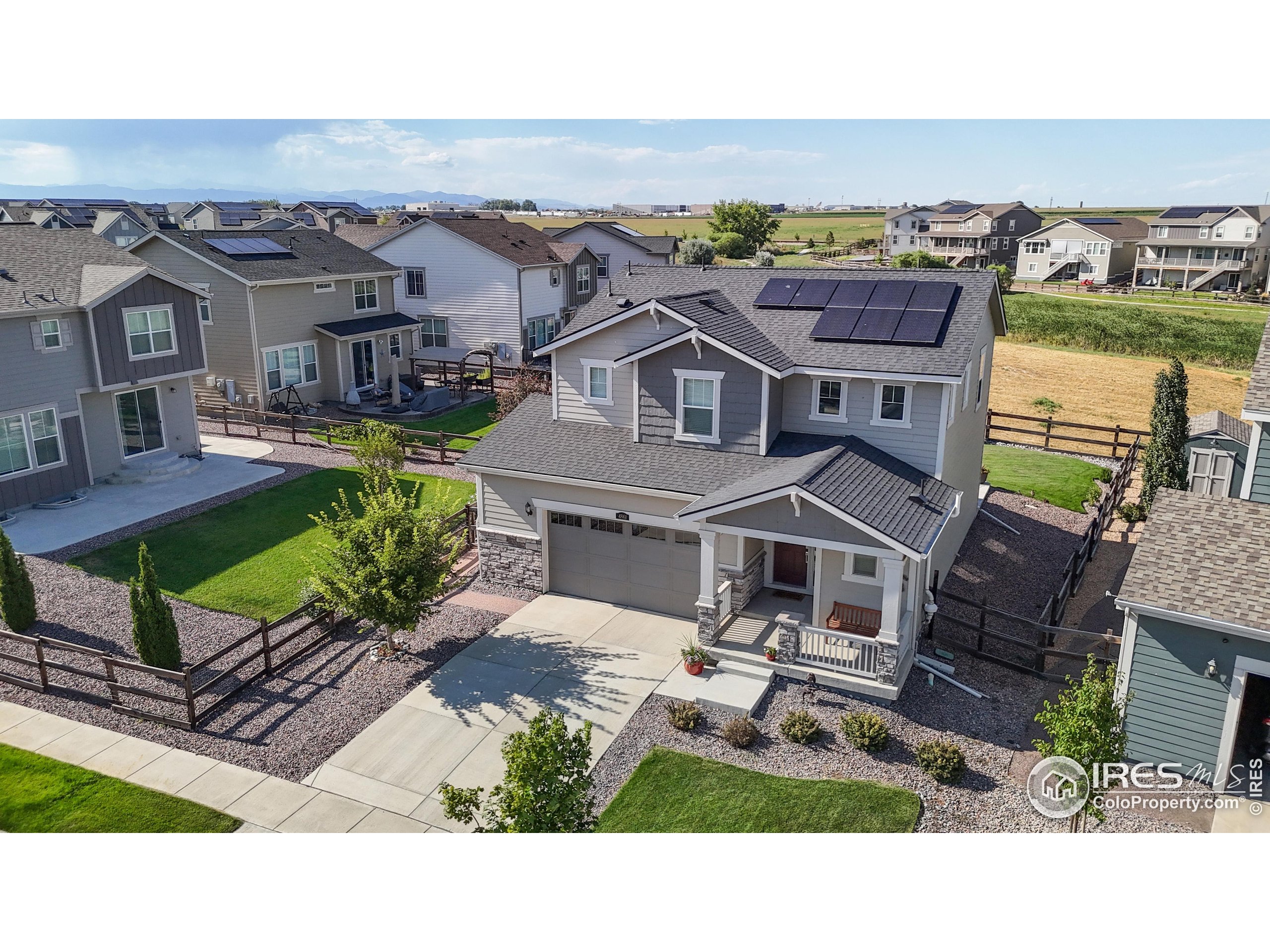 4861 St Vrain Road Firestone, CO 80504 - Photo 28 of 43 an aerial view of a house with a garden and lake view