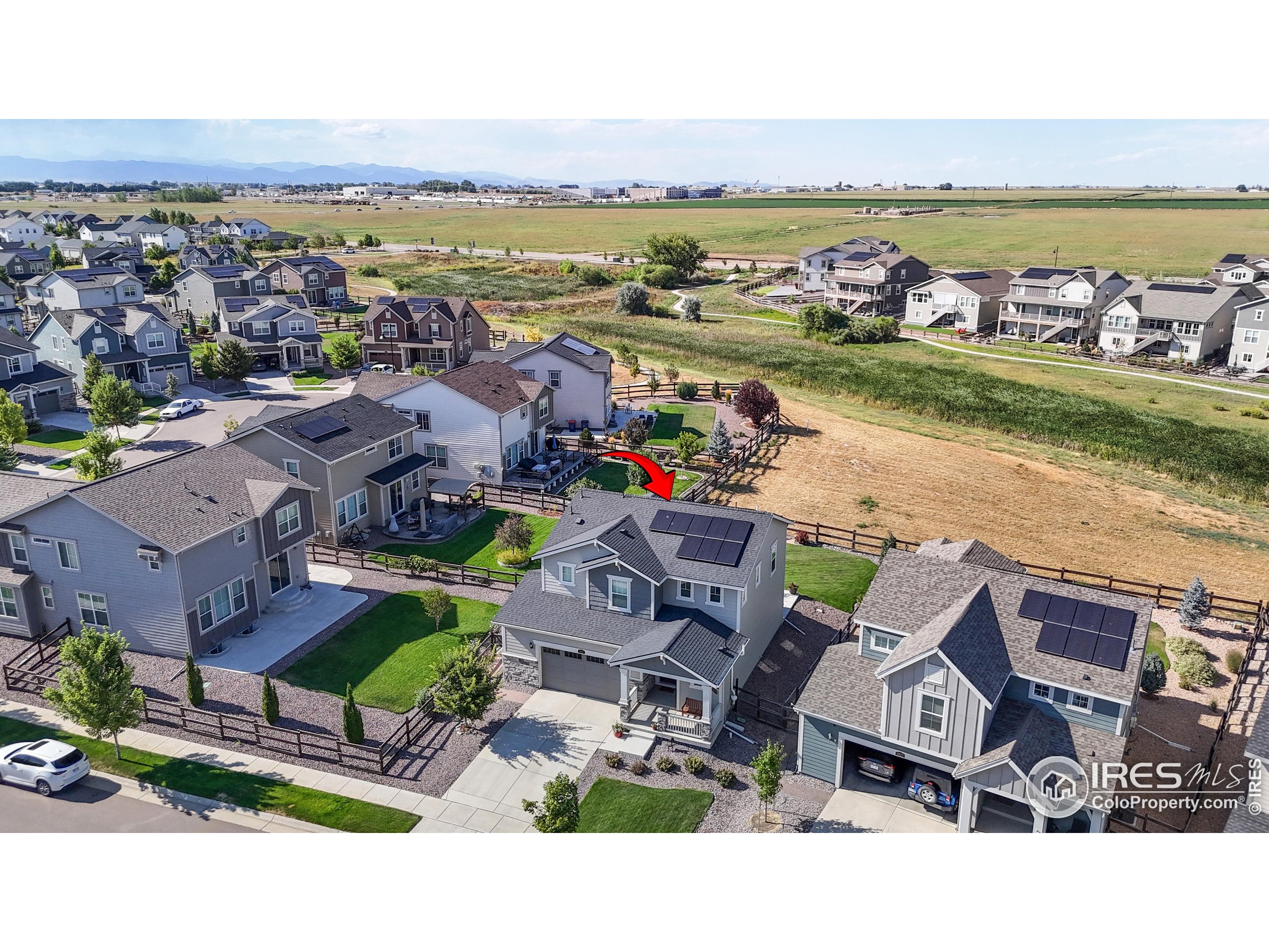 4861 St Vrain Road Firestone, CO 80504 - Photo 33 of 43 an aerial view of a city with lots of residential buildings and ocean view in back