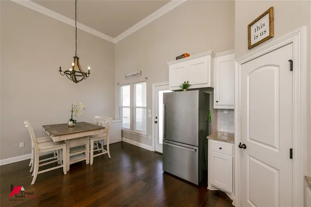 a kitchen with stainless steel appliances granite countertop a refrigerator a sink and a stove