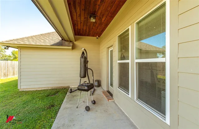 a view of a house with a wooden floor and a small yard