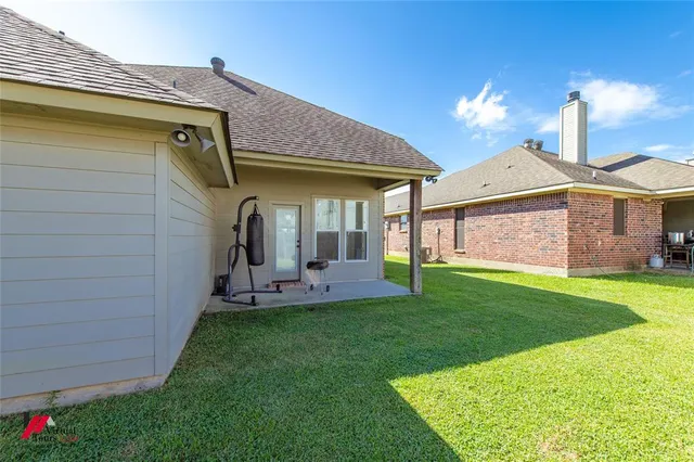 a front view of a house with a garden and patio