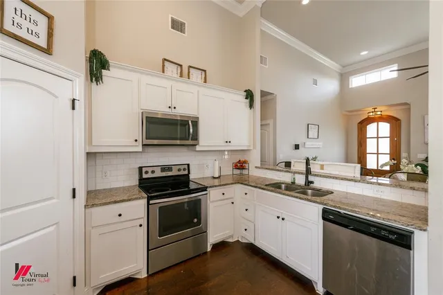 a kitchen with a sink stove and microwave