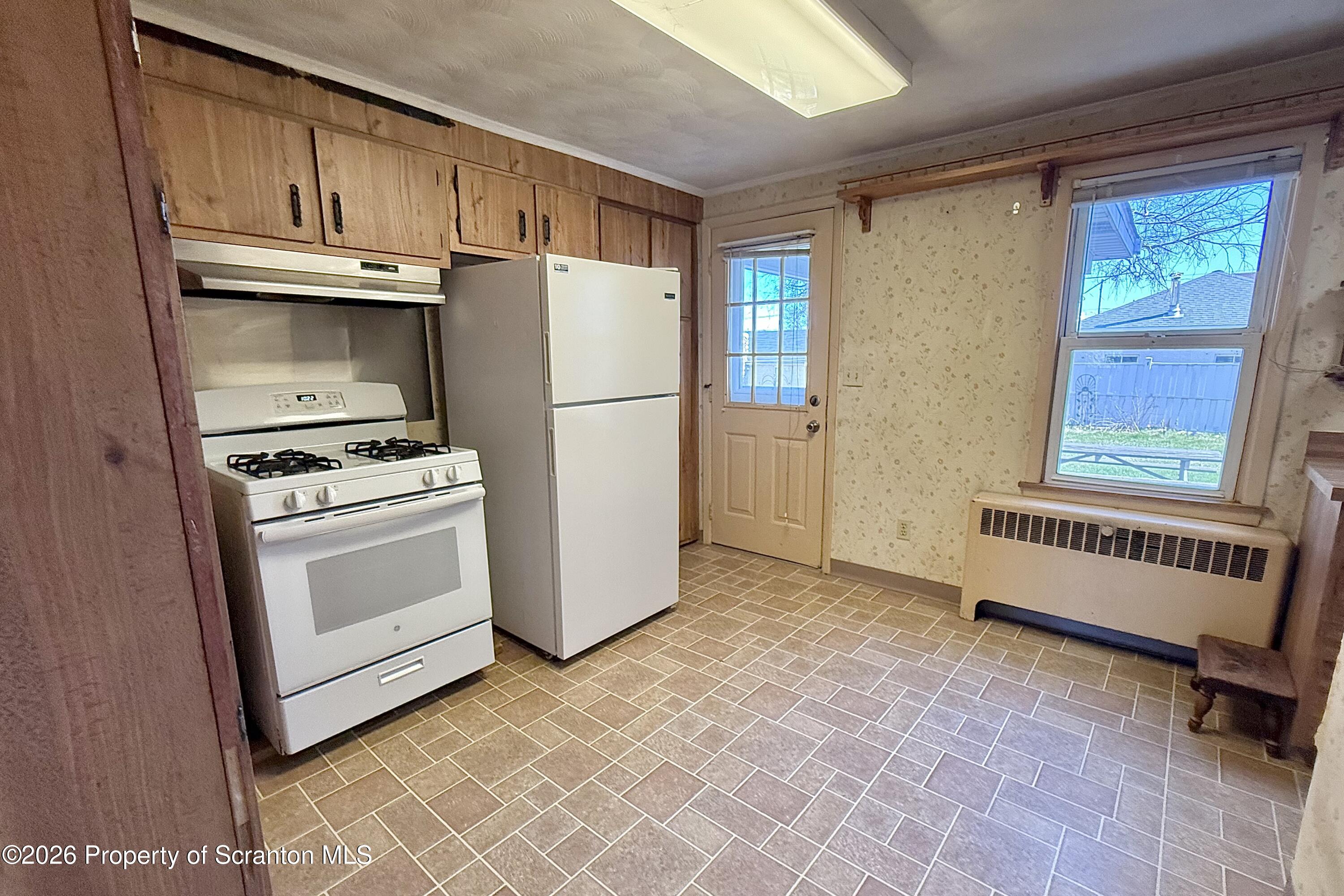313 Dolph Street Jessup, PA 18434 - Photo 11 of 29 a kitchen with white cabinets and white appliances