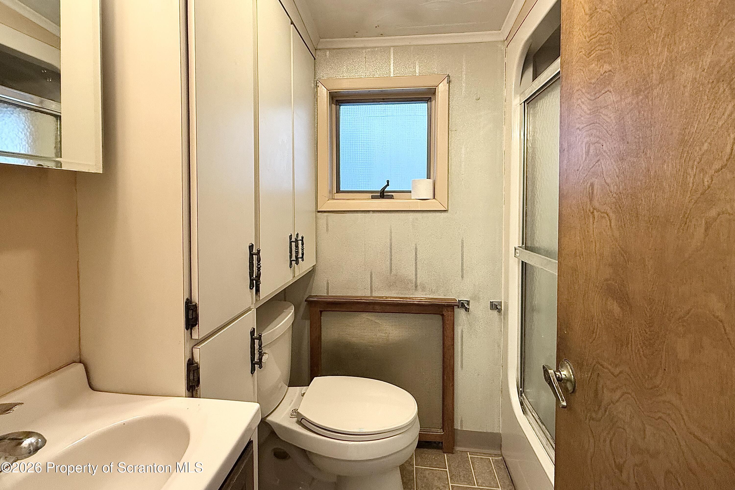 313 Dolph Street Jessup, PA 18434 - Photo 20 of 29 a bathroom with a sink and toilet