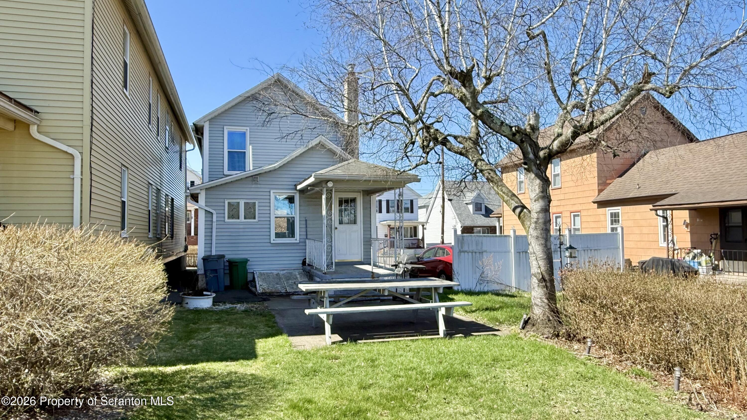 313 Dolph Street Jessup, PA 18434 - Photo 3 of 29 a front view of a house with a yard table and chairs