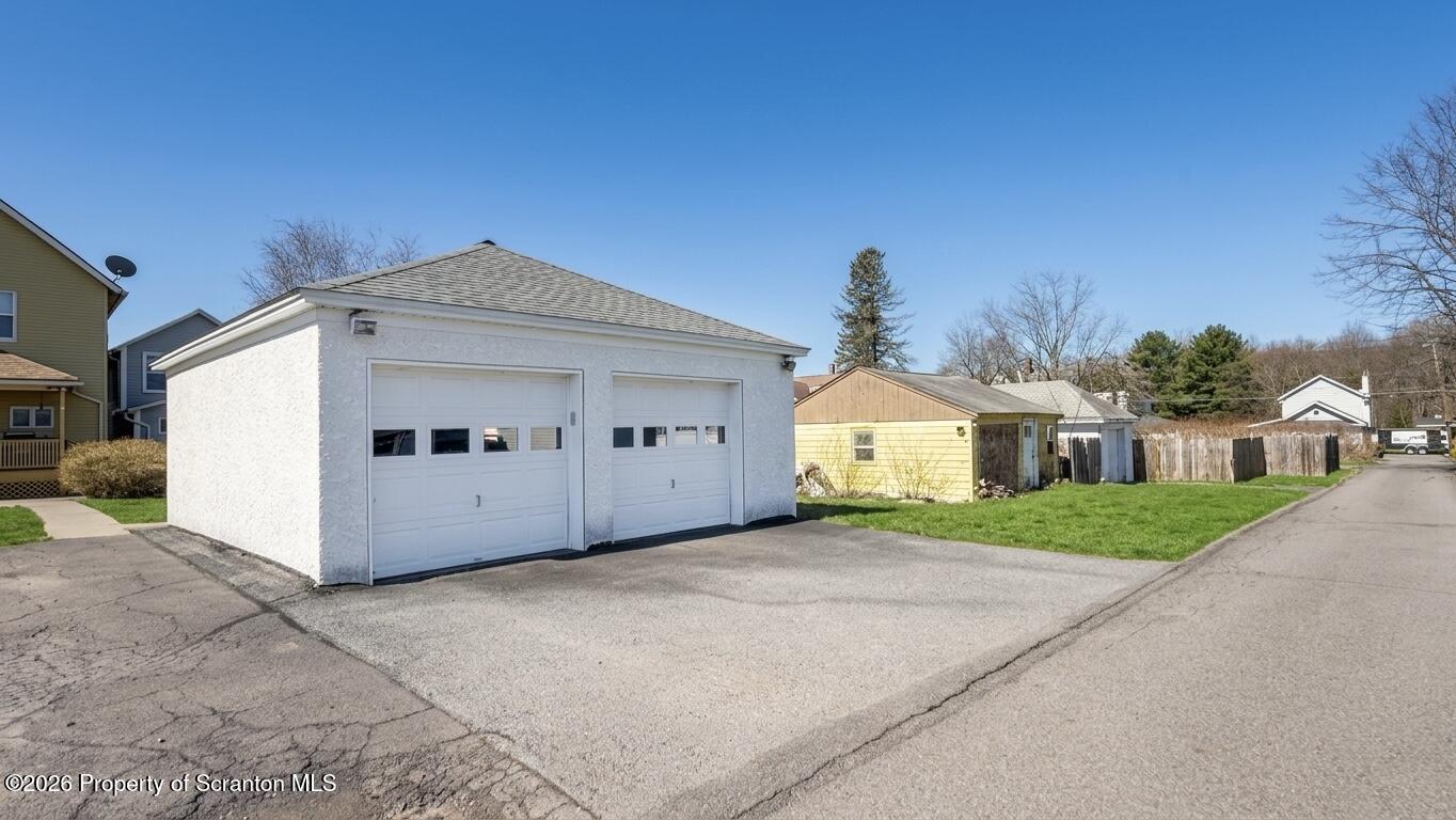313 Dolph Street Jessup, PA 18434 - Photo 6 of 29 a front view of a house with a yard and garage