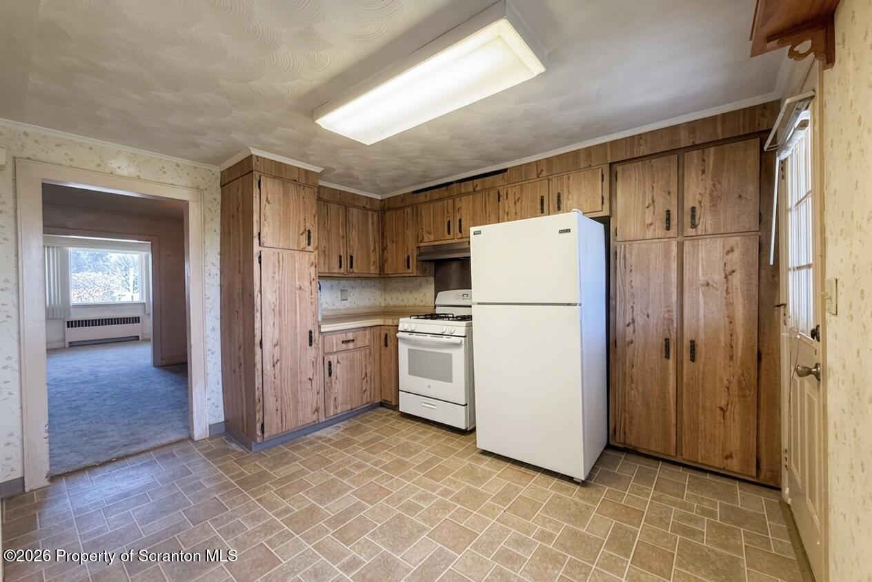 313 Dolph Street Jessup, PA 18434 - Photo 7 of 29 a view of a kitchen with refrigerator and more cabinets
