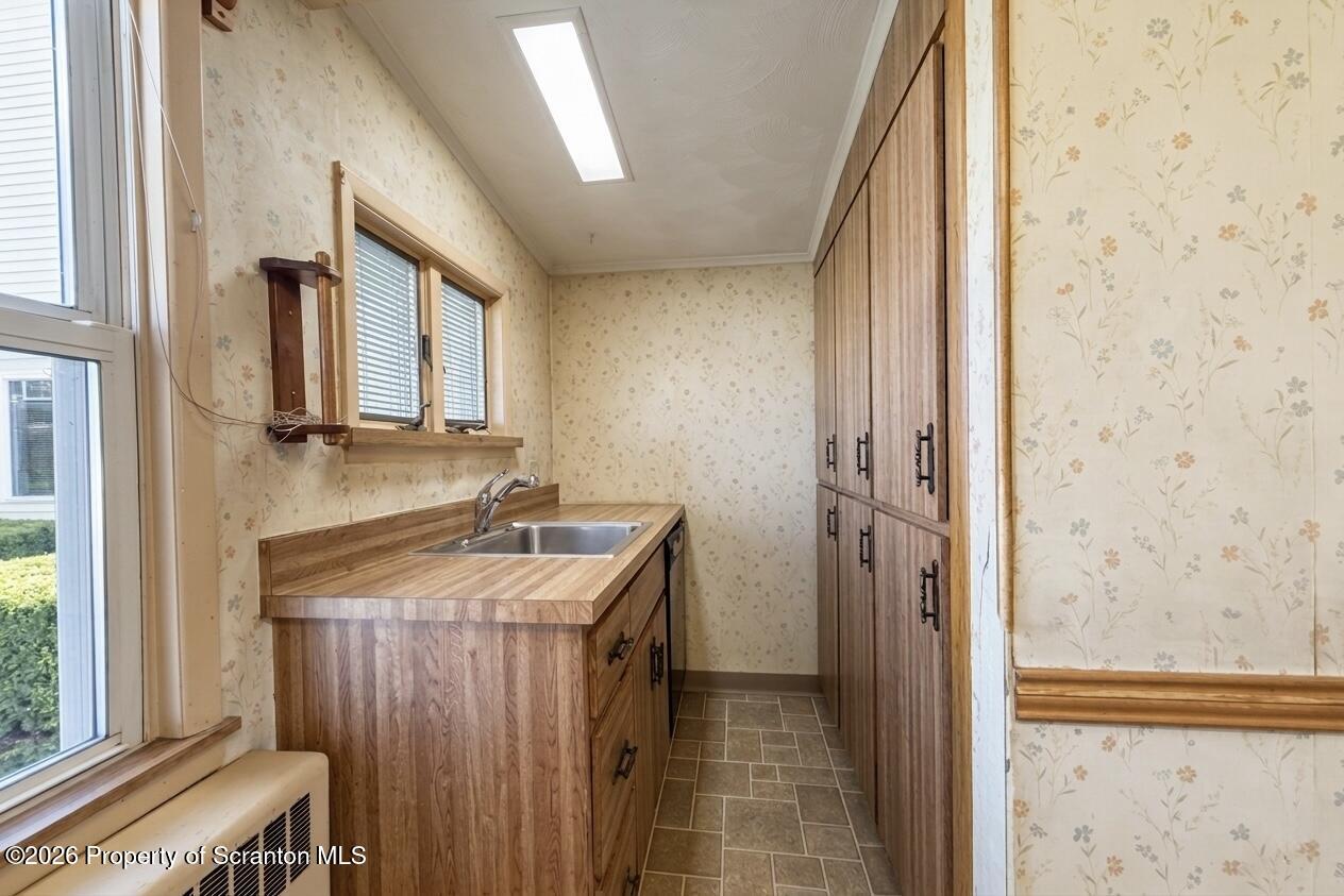 313 Dolph Street Jessup, PA 18434 - Photo 9 of 29 a bathroom with a granite countertop sink a mirror and shower