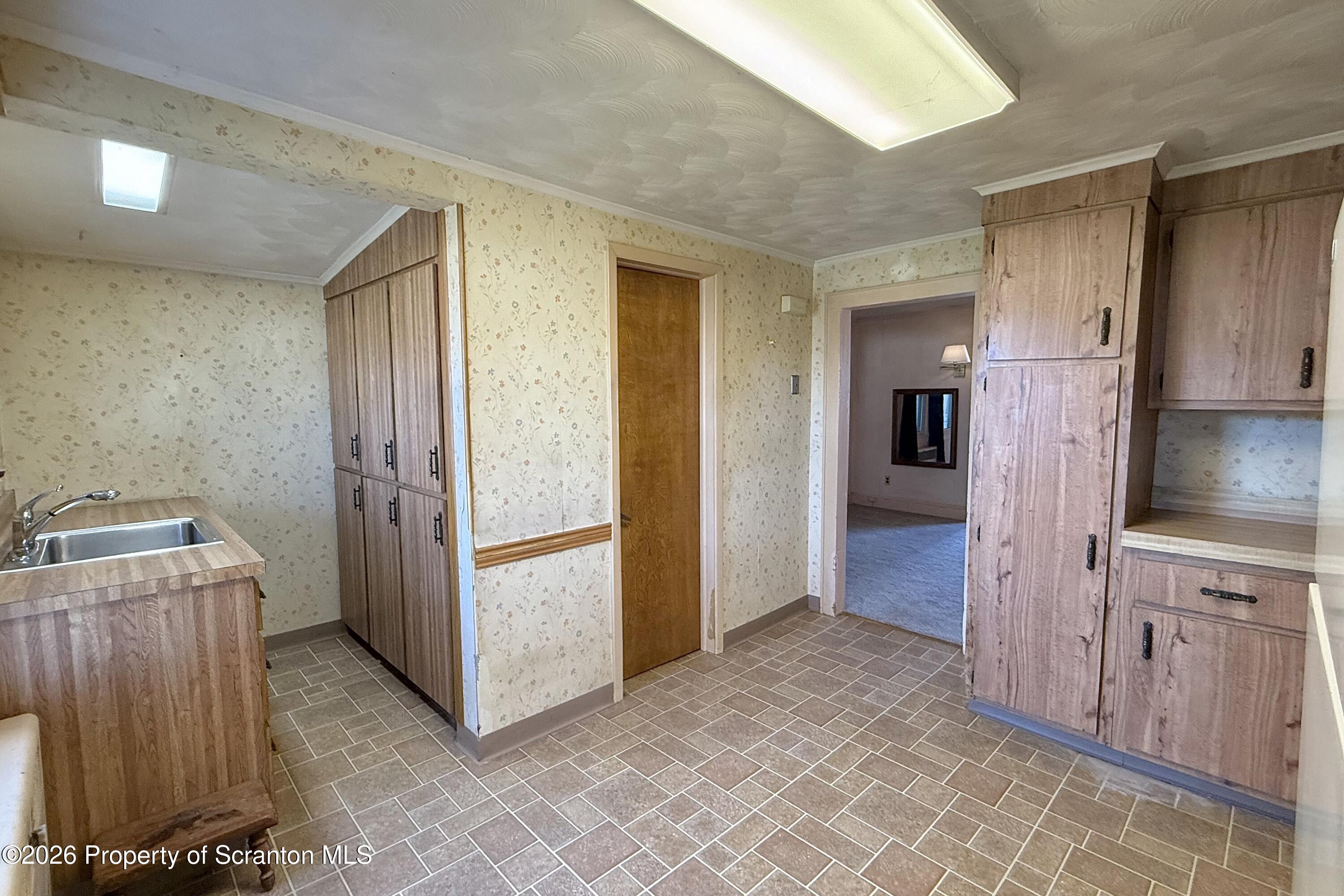 313 Dolph Street Jessup, PA 18434 - Photo 10 of 29 a view of a kitchen with refrigerator and microwave