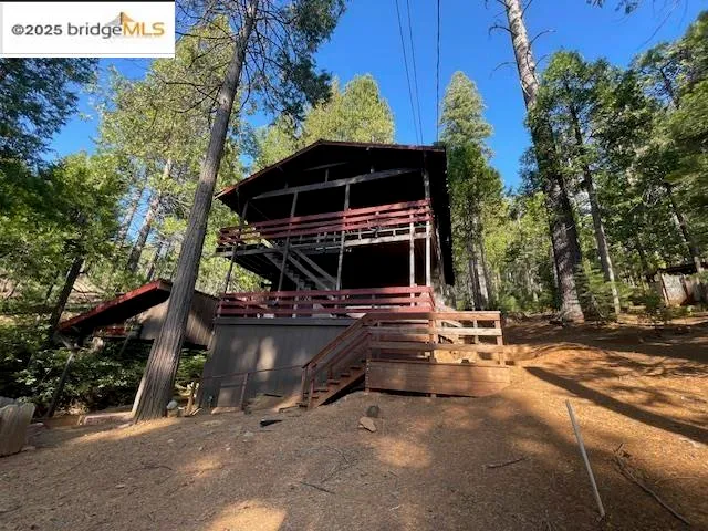 a view of a patio with a table and chairs under an umbrella