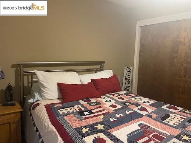 a bedroom with a bed and a chair