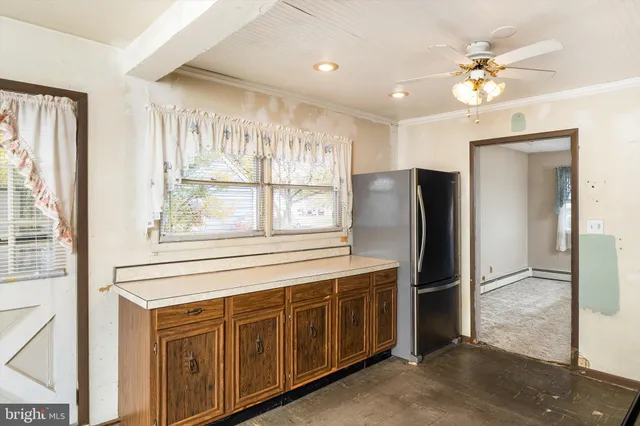 a kitchen with stainless steel appliances granite countertop a refrigerator a sink a stove and a window