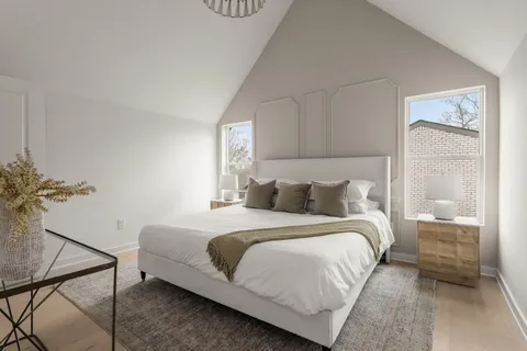 a bedroom with a bed and a potted plant