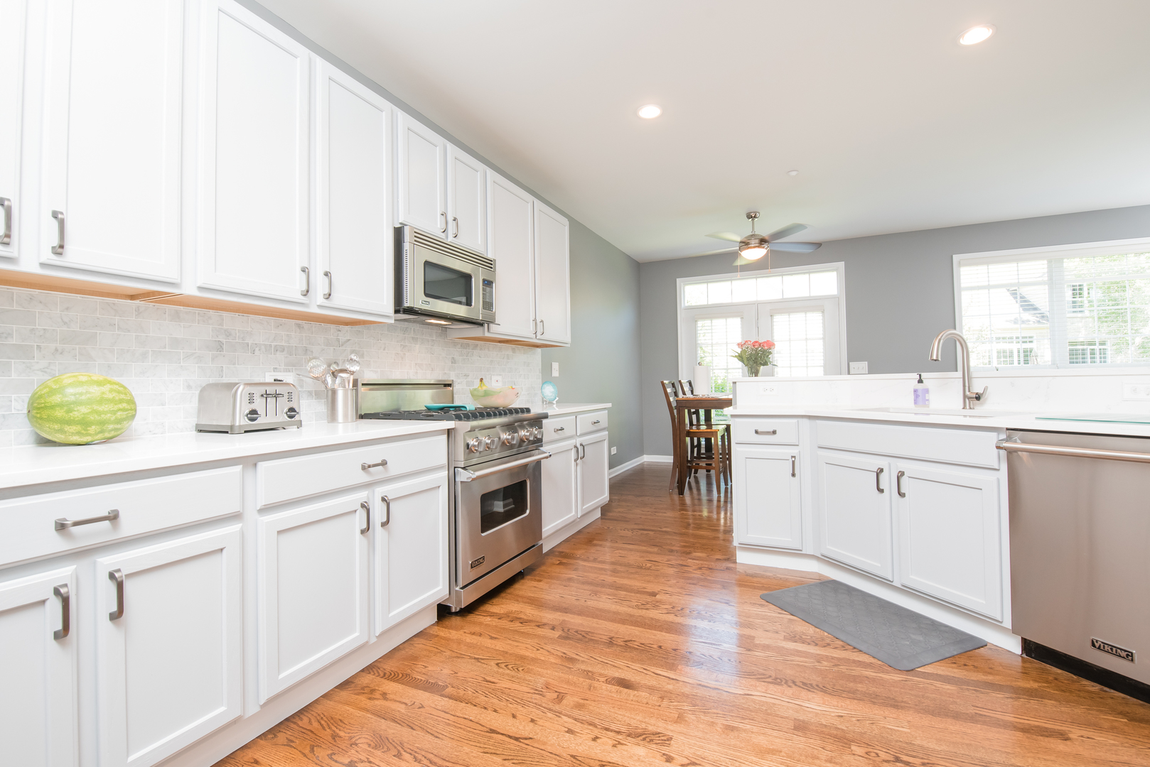 524 Bridgestone Court Inverness, IL 60010 - Photo 15 of 44 a kitchen with granite countertop white cabinets and white appliances