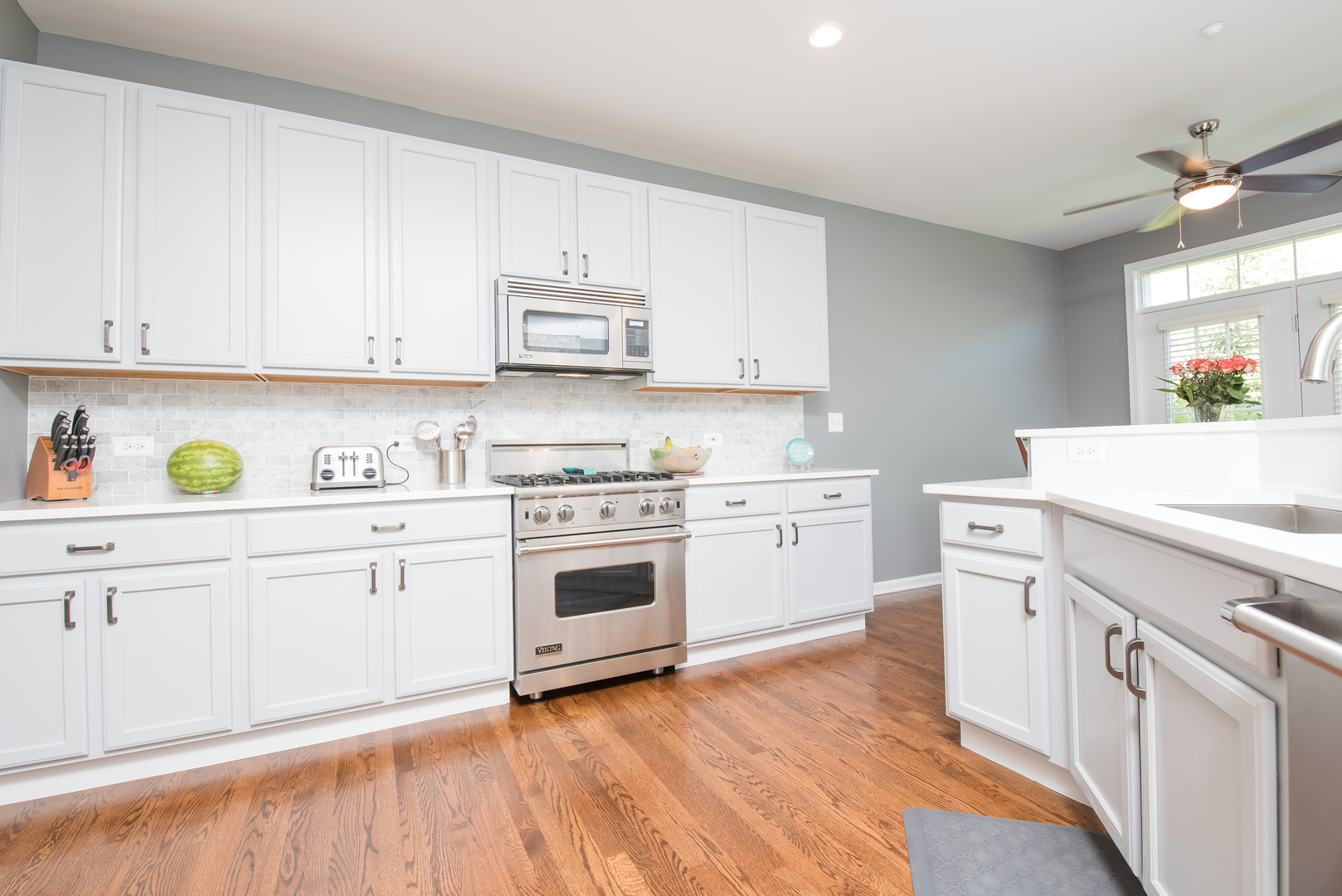 524 Bridgestone Court Inverness, IL 60010 - Photo 16 of 44 a kitchen with white cabinets white stainless steel appliances and sink