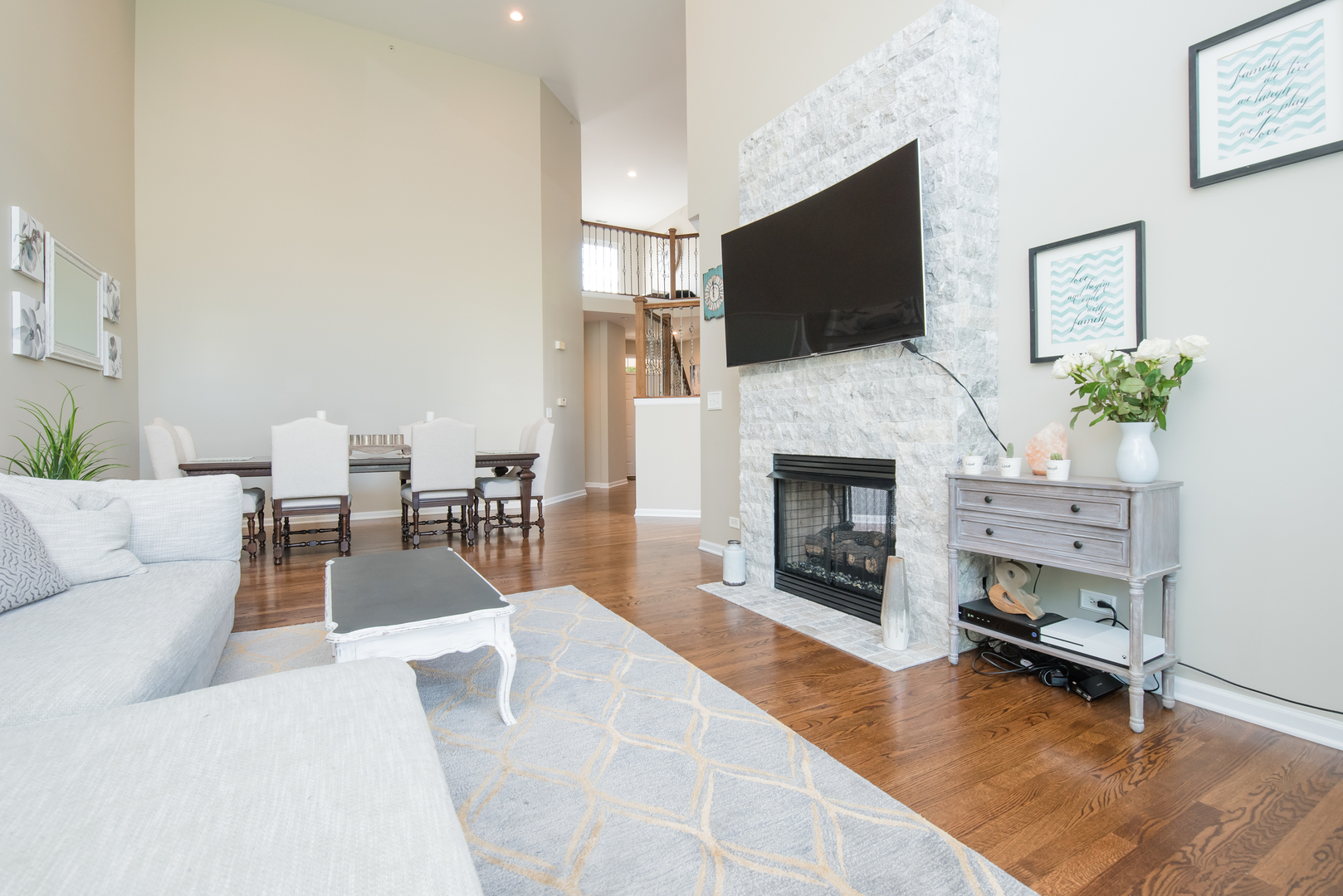 524 Bridgestone Court Inverness, IL 60010 - Photo 10 of 44 a living room with furniture a fireplace and a flat screen tv