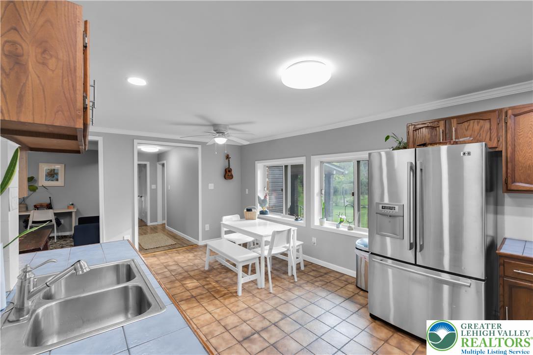 2242 Church Road Bethlehem, PA 18015 - Photo 18 of 74 a kitchen with a refrigerator a table and chairs